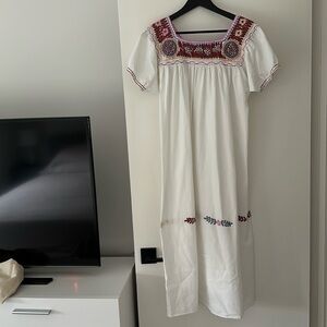 Vintage white cotton gauze dress with embroidered detailing .